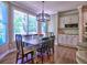 Sunlit breakfast nook features hardwood floors, charming light fixture and convenient access to the backyard at 658 Vinings Estates Se Dr, Mableton, GA 30126