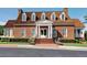 Classic brick clubhouse with a welcoming entrance and manicured landscaping at 658 Vinings Estates Se Dr, Mableton, GA 30126