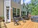 Spacious wooden deck featuring outdoor seating and a grill, perfect for entertaining overlooking the lush backyard at 658 Vinings Estates Se Dr, Mableton, GA 30126