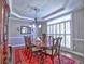 Formal dining room with hardwood floors, elegant chandelier, and traditional decor at 658 Vinings Estates Se Dr, Mableton, GA 30126