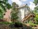 The rear exterior of this residence displays its multi-story deck and backyard landscape at 658 Vinings Estates Se Dr, Mableton, GA 30126