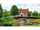 Stunning traditional-style brick home with a beautifully landscaped front yard and waterfall feature at 658 Vinings Estates Se Dr, Mableton, GA 30126