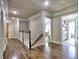 Upstairs hallway with hardwood flooring and an abundance of natural light leading to bedrooms and a laundry room at 658 Vinings Estates Se Dr, Mableton, GA 30126