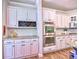 Kitchen boasts stainless appliances, wine rack, custom cabinets, and double ovens, perfect for cooking enthusiasts at 658 Vinings Estates Se Dr, Mableton, GA 30126