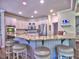 Open concept kitchen features an island with bar stool seating, stainless steel appliances, and granite countertops at 658 Vinings Estates Se Dr, Mableton, GA 30126