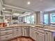 Kitchen has granite countertops, stainless steel appliances, white cabinets, and open views to the living room at 658 Vinings Estates Se Dr, Mableton, GA 30126