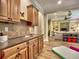 A well-appointed kitchenette with wood cabinetry, a tiled backsplash, and an open view to the expansive recreation room at 658 Vinings Estates Se Dr, Mableton, GA 30126