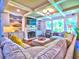 Bright living room featuring a fireplace, built-in shelving, coffered ceilings, and large windows with natural light at 658 Vinings Estates Se Dr, Mableton, GA 30126