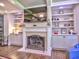 This living room includes a fireplace, a wall mounted television, and built-in shelving on either side at 658 Vinings Estates Se Dr, Mableton, GA 30126