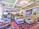 Open concept living room and kitchen includes a large sectional sofa, island seating, and modern appliances at 658 Vinings Estates Se Dr, Mableton, GA 30126
