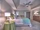 Spacious main bedroom with tray ceiling, fan, and en suite bathroom access at 658 Vinings Estates Se Dr, Mableton, GA 30126