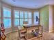 Bright office features a desk setup, neutral paint, and windows that bring in ample light for a productive work space at 658 Vinings Estates Se Dr, Mableton, GA 30126