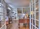 Home office with french doors, custom bookshelves, and natural light, ideal for productivity at 658 Vinings Estates Se Dr, Mableton, GA 30126