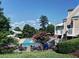 View of the community pool with lounge chairs and a colorful splash pad at 658 Vinings Estates Se Dr, Mableton, GA 30126