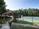 Outdoor community tennis court with landscaping and walkway at 658 Vinings Estates Se Dr, Mableton, GA 30126