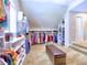 Spacious walk-in closet with rows of hanging clothes and long storage benches at 658 Vinings Estates Se Dr, Mableton, GA 30126