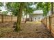 Serene backyard featuring mature trees, a fire pit, and a privacy fence at 1296 Plaza Sw Ave, Atlanta, GA 30310