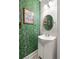 Charming bathroom with green wallpaper and a pedestal sink at 1296 Plaza Sw Ave, Atlanta, GA 30310