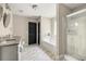 Modern bathroom with gray marble floors, a double vanity, a glass enclosed shower, and a soaking tub at 1296 Plaza Sw Ave, Atlanta, GA 30310