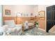 Cozy bedroom featuring soft carpeting, a rocker chair, and a wooden crib at 1296 Plaza Sw Ave, Atlanta, GA 30310
