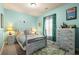 Comfortable bedroom with vintage furniture and ample natural light at 1296 Plaza Sw Ave, Atlanta, GA 30310