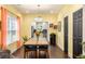Bright dining room with a large wooden table and view of the adjacent kitchen at 1296 Plaza Sw Ave, Atlanta, GA 30310