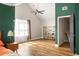 Spacious bedroom featuring wood floors, a fan, a large window, and dark trim at 1296 Plaza Sw Ave, Atlanta, GA 30310