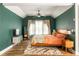 Charming bedroom with wood flooring, high ceilings, neutral curtains, and modern furniture and decor at 1296 Plaza Sw Ave, Atlanta, GA 30310