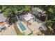 Aerial view of the home showcasing the backyard pool, patio, and surrounding mature trees at 1423 Briarcliff Ne Rd, Atlanta, GA 30306