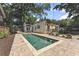 Backyard featuring pool, travertine patio, and a well-maintained fence line at 1423 Briarcliff Ne Rd, Atlanta, GA 30306