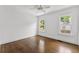 Bright bedroom with hardwood floors, two windows and simple decor at 1423 Briarcliff Ne Rd, Atlanta, GA 30306