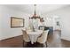 Cozy dining room with hardwood floors, chandelier, and an archway to the open kitchen at 1423 Briarcliff Ne Rd, Atlanta, GA 30306