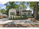 Charming home with a landscaped front yard, awning-covered porch, and large windows at 1423 Briarcliff Ne Rd, Atlanta, GA 30306