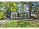 Charming home featuring a landscaped front yard, awning-covered porch, and a long driveway at 1423 Briarcliff Ne Rd, Atlanta, GA 30306