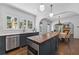 Well-lit kitchen with stainless steel appliances, center island with butcher block top and view to the adjacent living room at 1423 Briarcliff Ne Rd, Atlanta, GA 30306