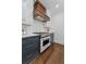 Gourmet kitchen with stainless steel appliances, including stove and range hood at 1423 Briarcliff Ne Rd, Atlanta, GA 30306