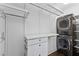 Convenient laundry area with stackable washer and dryer, drawers and shelving for organized storage at 1423 Briarcliff Ne Rd, Atlanta, GA 30306