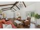 Spacious living area with wood beams, fireplace, hardwood floors, and abundant natural light at 1423 Briarcliff Ne Rd, Atlanta, GA 30306