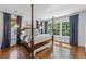 Main bedroom with hardwood floors, natural light and a four-poster bed with views to the outdoors at 1423 Briarcliff Ne Rd, Atlanta, GA 30306