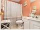 A bathroom features a shower with a curtain, white cabinets, and pink walls at 3372 Springside Rdg, Decatur, GA 30034