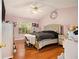 Bedroom boasts light-purple walls, hardwood floors, a ceiling fan, and a large window at 3372 Springside Rdg, Decatur, GA 30034