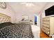 Bedroom boasts light-purple walls, hardwood floors, a ceiling fan, and a TV at 3372 Springside Rdg, Decatur, GA 30034