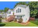 Side view of split-level home with attached garage, wood stairs to front door, and well-manicured lawn at 3372 Springside Rdg, Decatur, GA 30034