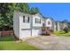 Side view of split-level home with attached garage, wood stairs to front door, and well-manicured lawn at 3372 Springside Rdg, Decatur, GA 30034