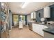 A kitchen features white cabinets, stainless steel appliances, tile flooring, and a dining area with chairs at 3372 Springside Rdg, Decatur, GA 30034