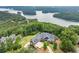 Aerial view of a beautiful home and surrounding landscape with lake views at 49 Waterside Se Dr, Cartersville, GA 30121