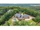 Aerial view of a beautiful home with a private pool and lush landscaping overlooking trees and a lake at 49 Waterside Se Dr, Cartersville, GA 30121