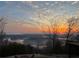Scenic sunrise view overlooking a lake with an in-ground pool and trees at 49 Waterside Se Dr, Cartersville, GA 30121