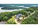 An aerial view showcases a luxurious estate with stunning lake and mountain views from its hilltop location at 49 Waterside Se Dr, Cartersville, GA 30121
