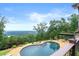 Scenic backyard with kidney-shaped pool and stunning mountain and lake views at 49 Waterside Se Dr, Cartersville, GA 30121